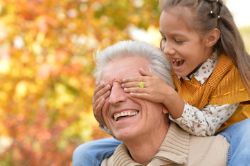 girl closeing eyes of granddaughter 