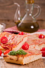 Italian pizza with cheese, tomatoes and fresh basil. 