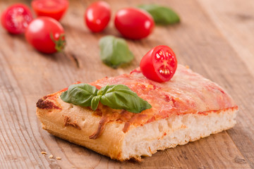 Fototapeta na wymiar Italian pizza with cheese, tomatoes and fresh basil. 