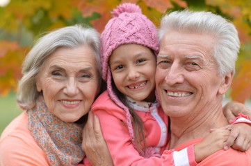 Fototapeta premium grandparents and granddaughter in park