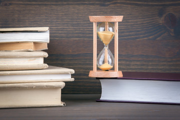Sandglass, hourglass or egg timer on wooden table showing the last second or last minute or time...
