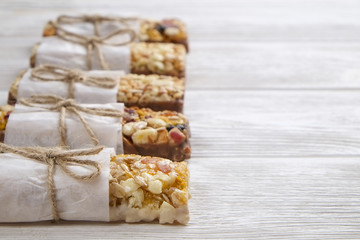 Homemade gluten free granola bars on wooden background. 