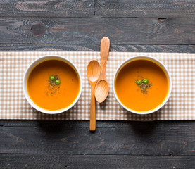 Homemade Pumpkin Soup on rustic wooden background, free space for text.