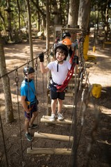 Portrait of cute boy standing on outdoor equipment