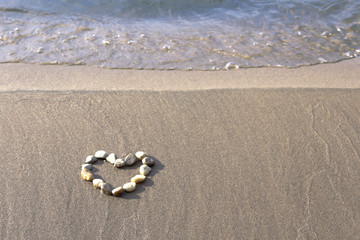 Stone heart on the beach Background Texture