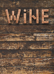 Word wine shaped by corks over dark vintage wood