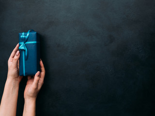 expensive luxury present for rich men on dark background. professional gift wrapping. worthy surprise for bithday, fathers day, valentines day, new year, christmas, thanksgiving and other holidays.