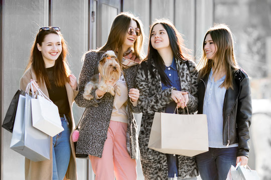 Group of happy friends shopping together.