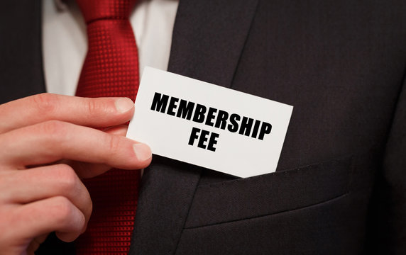 Businessman putting a card with text MEMBERSHIP FEE in the pocket