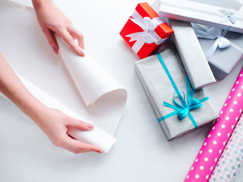 Woman Hands Wrapping Paper. Selection Of Already Packed Presents. Gift Shop Concept