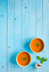 Homemade Pumpkin Soup on rustic wooden background, free space for text.