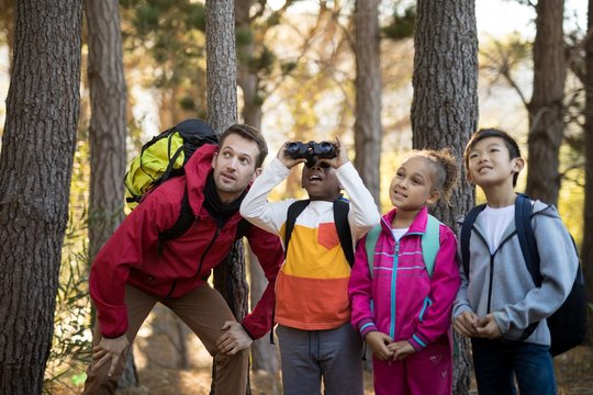 Teacher and kids exploring in park