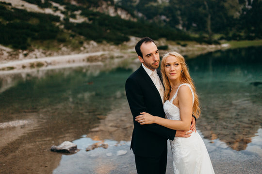 Beautiful wedding couple near the lake in the Alps