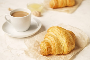  French breakfast with fresh croissants, raw honey and cappuccino. 
