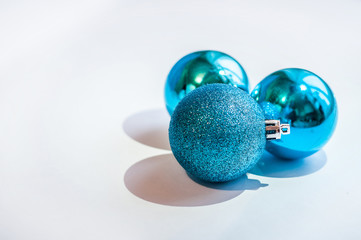 Three blue decoration balls on a white background. New Year and Christmas decoration.