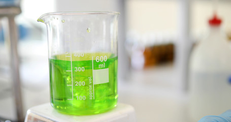 Mechanical stirring, liquid of green color is mixed in a round flask.