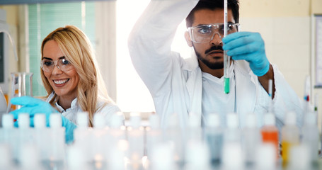 Young students of chemistry working in laboratory