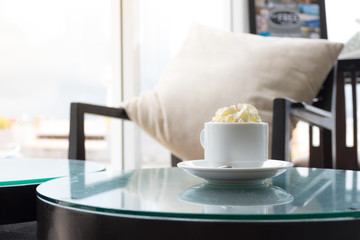 Morning time with hot Chocolate and topping with whip cream on the top ready to serve in a coffee shop