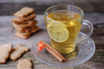green tea with lemon, ginger biscuits at the little animals on the table