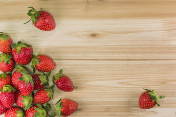 Red strawberries on wooden background with copy space. for text.Top view