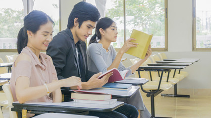 people student read book and sit in lecture chairs