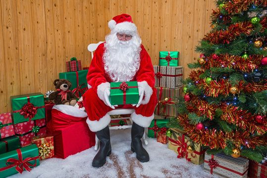 Santa Claus in a grotto giving you a gift.