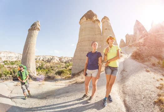 Multicultural friends travel and having fun at old ancient Zelve town in Cappadocia, Turkey