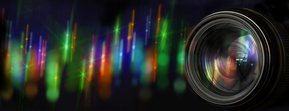 Photo lens with original background with blurred flares of street lights at night