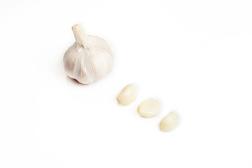 Fresh peeled and unpeeled garlic on a white background