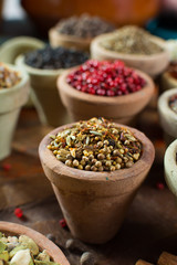 Variety of different asian and middle east spices, colorful assortment, on old wooden table