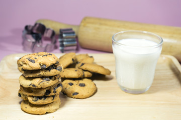 MILK GLASS AND CRACKERS A glass of milk with pile of crackers on the wood top table.