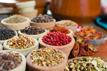 Variety of different asian and middle east spices, colorful assortment, on old wooden table