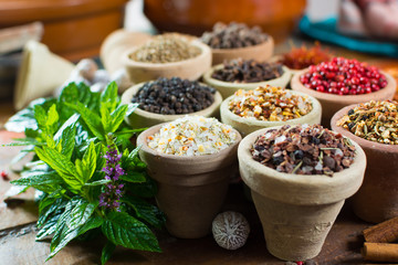 Variety of different asian and middle east spices, colorful assortment, on old wooden table