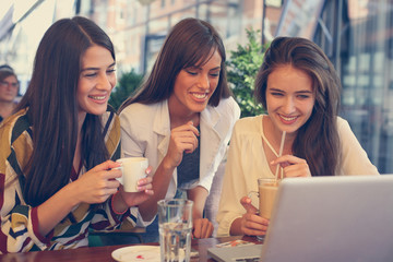Young women at coffee break. Outside.