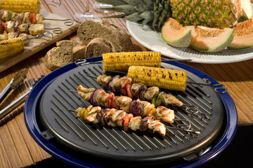 Tasty crispy chicken with baked vegetables on the centerpiece of table