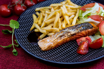 grilled salmon and lemon - french cuisine dish with tomato and salmon