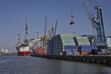big container ships with cranes in the harbor of rotterdam