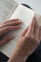 Close up hands with open book for reading concept
