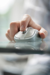 man using his vingers to control a cordless mouse