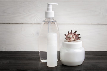 Spa beauty cosmetic products on white and black wooden background. Copyspace
