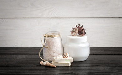 Spa beauty cosmetic products on white and black wooden background. Copyspace