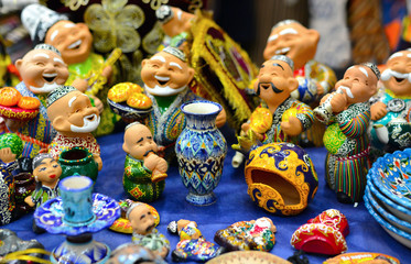 Ceramic plates and  figures of Uzbek men n in traditional clothing - robe and a skullcap, painted plates
