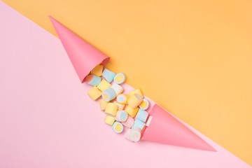 Minimal flat lay. Top view of the pastel marshmallows on a pinkbackground.