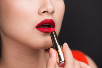Professional Make-up. Attractive asian model applying red lipstick.