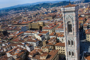 Fototapeta na wymiar Aerial view of Giotto's Bell Tower in Florence from the top of the Duomo