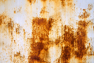 Rusty grunge background. Rusty old metal wall with the peeled white paint 