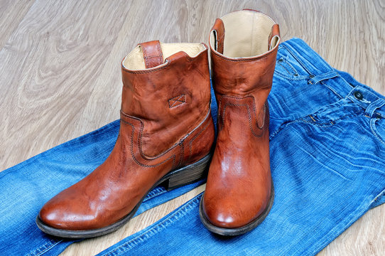 Brown cowboy boots on blue jeans