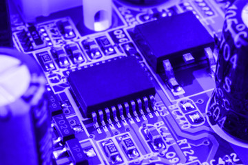 Integrated semiconductor microchip on blue circuit board representative of the high tech industry and computer science