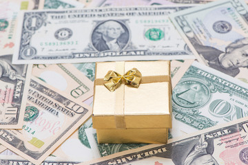The gold gift box on banknote background