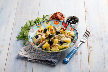 salad with potatoes anchovies dried tomatoes and black olives